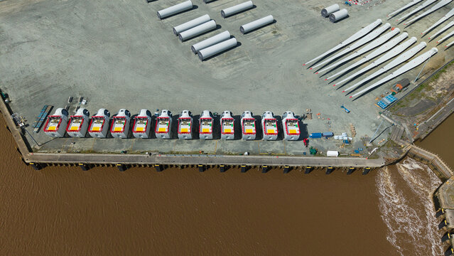 Aerial view of Siemens Gamesa Renewable Energy facility with wind turbine nacelles and blades stored at the port in Kingston upon Hull, England, United Kingdom.