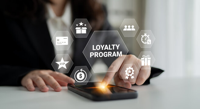 A business professional interacts with a smartphone displaying a loyalty program interface. Digital icons illustrate features, showcasing modern technology in customer engagement. Ledger