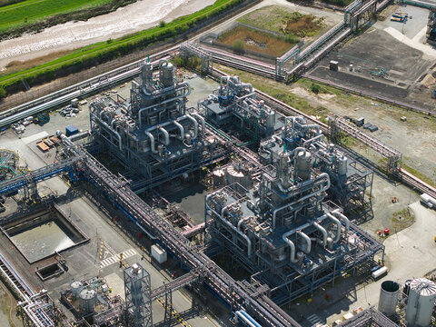 Aerial view of the Salt End industrial facility featuring complex steel piping, distillation towers, and storage tanks under bright daylight in Salt End, England, United Kingdom.