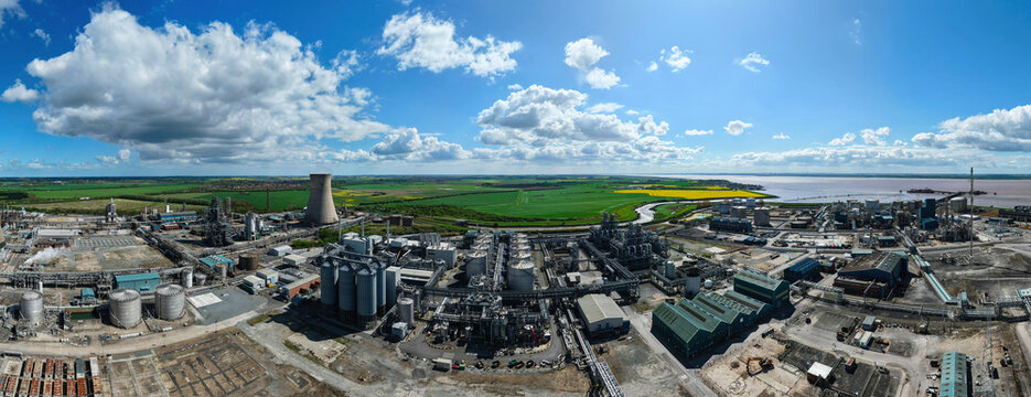 Aerial view of the Salt End Chemicals Park industrial complex with cooling towers and storage tanks under a cloudy blue sky Salt End, England, United Kingdom.