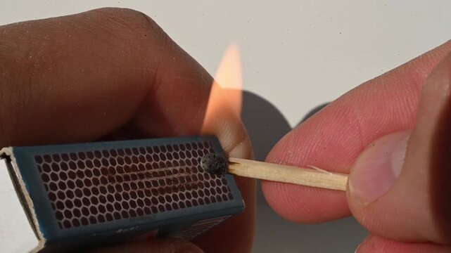 Lighting a match in slow motion - macro close up