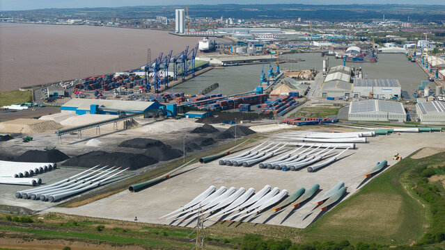 Aerial view of the Salt End industrial area featuring wind turbine blades stored near the port and shipping containers Salt End, England, United Kingdom.