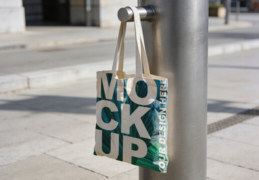 Canvas Tote Bag Mockup Hanging on Metal Pole - Urban Lifestyle
