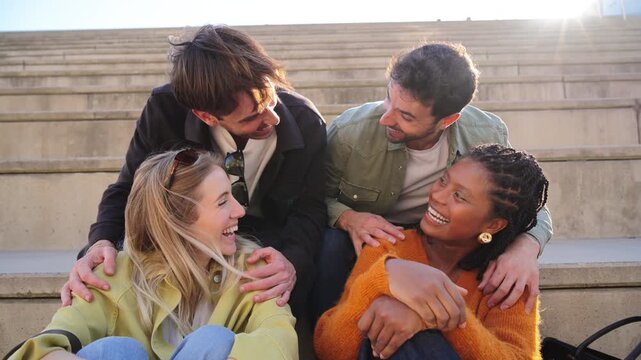 A group of four cheerful friends embrace their friendship while laughing and posing playfully for the camera, capturing a moment of joy and connection that reflects their strong bond.
