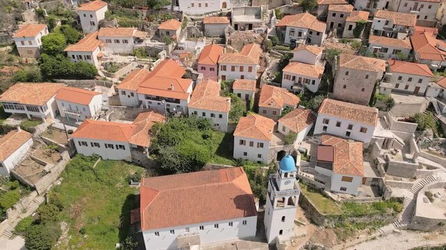 Traditional orange rooftop stone houses and iconic Holy Church of Saint Spyridon