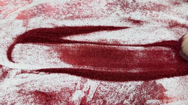 Red glitter spells '2027' on white background. Creative abstract background for new year or future themes. Artistic texture perfect for holiday, celebration, or futuristic designs