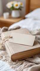 Fototapeta premium Cozy bedroom scene with book and bookmark on soft beige blanket