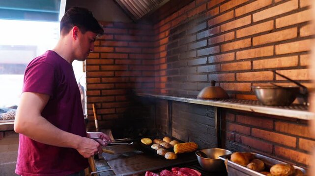 Chef cooking meat steaks and vegetables on barbecue grill