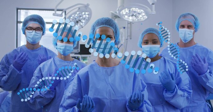 Standing surgical team posing in operating room, wearing gowns, masks, caps, gloves, DNA overlay