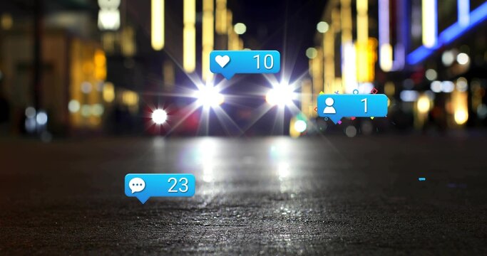 Shining car headlights creating lens flares over shiny pavement on urban street, with blue bubbles