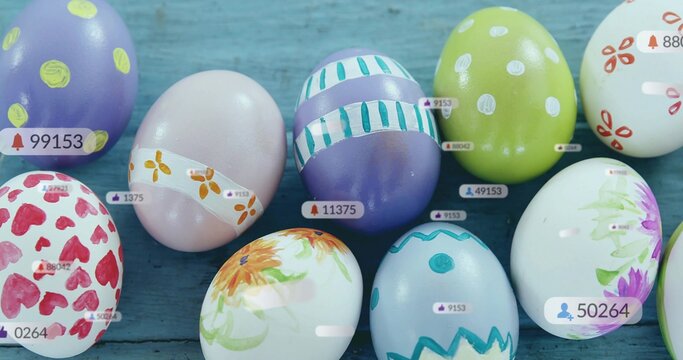 Displaying cluster of decorated eggs sitting on blue painted plank surface, with overlay tags
