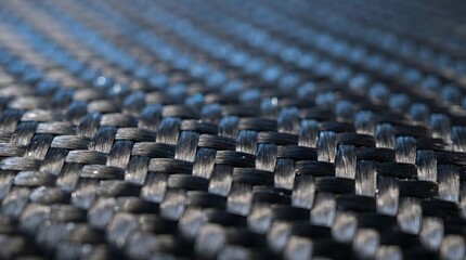Fototapeta premium Close-up of glossy carbon fiber weave texture with diagonal pattern and reflective surface