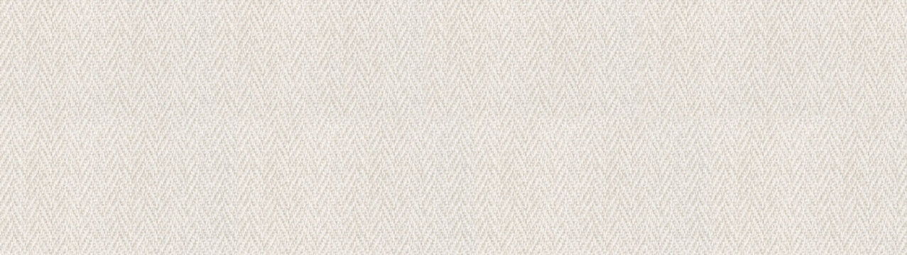 High resolution texture of cream colored herringbone fabric provides a sophisticated textile background for elegant fashion or interior design concepts.