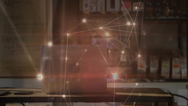 Animated overlay appearing over cafe, nodes drifting and forming flares behind laptop to sell item