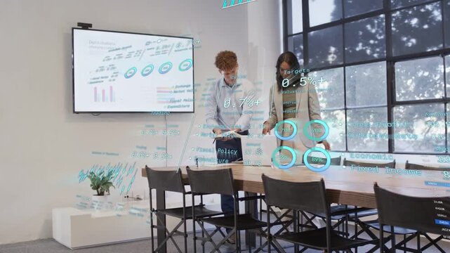 Man tapping tablet showing business holo charts while woman adjusting UI and reviewing data