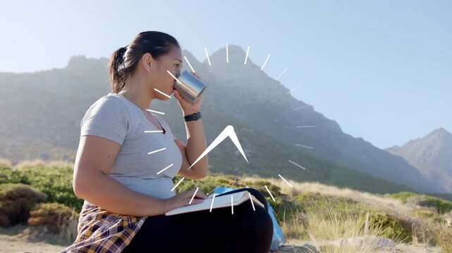 Woman hiker taking break sitting on ground clock rotating switching sipping cup and writing journal