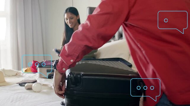 Couple packing for travel on bed, man closing suitcase as woman folding clothes, bubbles guiding