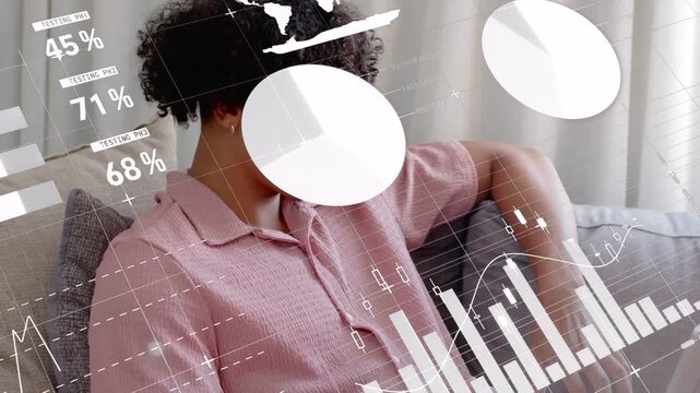 Man on sofa glancing, leaning and typing on laptop, causing HUD overlay across torso for analytics