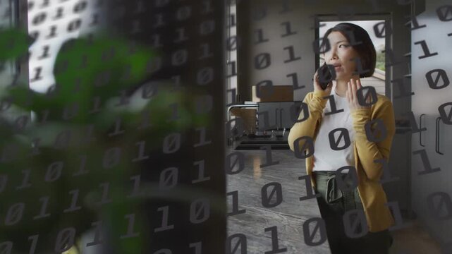 Woman entering and moving through tech studio taking work call while binary overlay obscuring entry