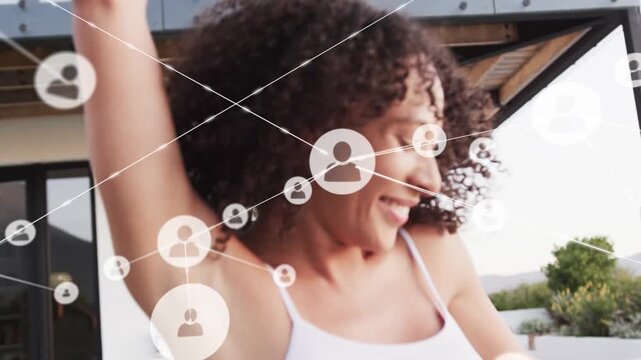 Curly-haired woman approaching deck, twirling to greet friend, clasping hands as tech icons expand