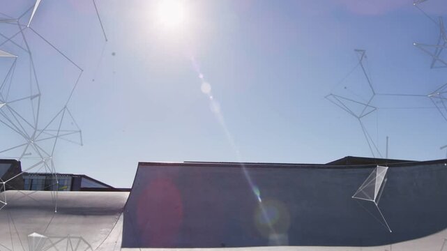Male rider dropping on ramp riding crest balancing as polys shifting over rider lens flare sports