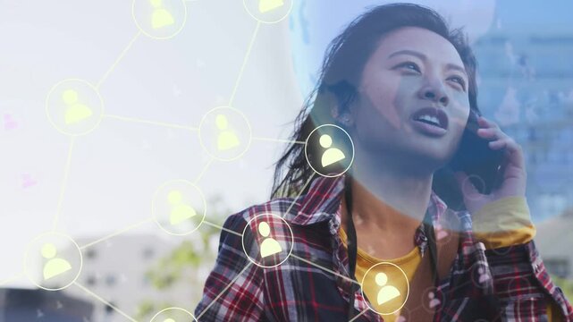 Woman walking city talking on phone call driving nodes into globe overlay visualizing tech network