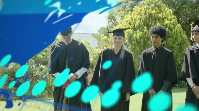 Grads clapping stepping on lawn celebrating graduation world map sweeping on one grad moving