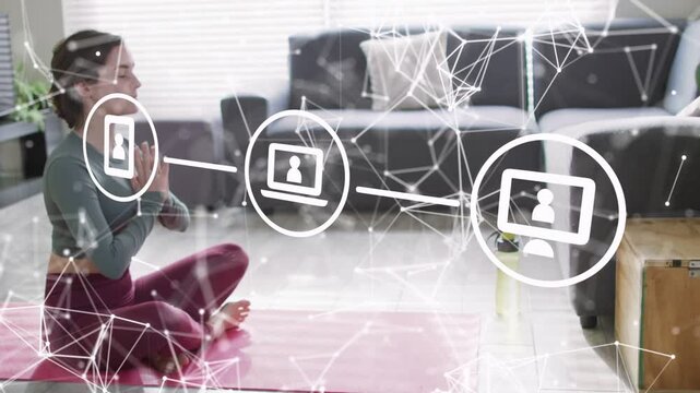 Woman meditating on pink mat animated overlay appearing near her and connecting icons for wellness