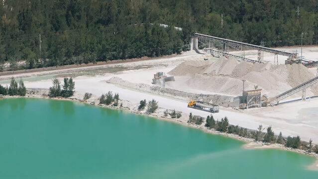 Limestone quarry operation with loader and haul truck