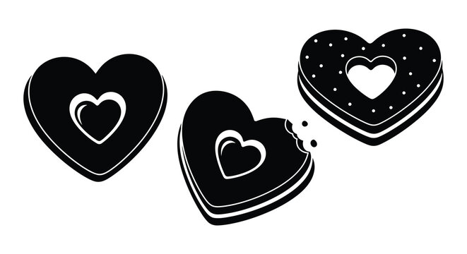 Three black heart shaped cookies with bite marks a striking silhouette