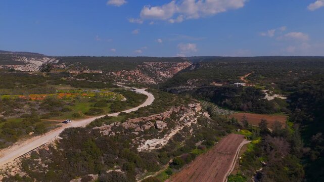 Aerial Pan Shot Revealing Avakas Gorge and Green Farmland in Paphos Cyprus