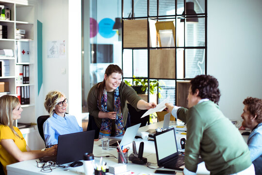 Coworkers collaborating in modern office meeting