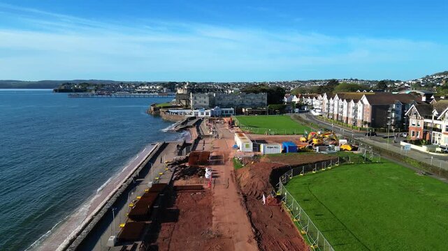 Paignton, Devon, England: DRONE VIEWS: A sea defence wall under construction on Preston Sands Green. The project will be completed in 2027 to protect seafront properties from global rising sea levels.