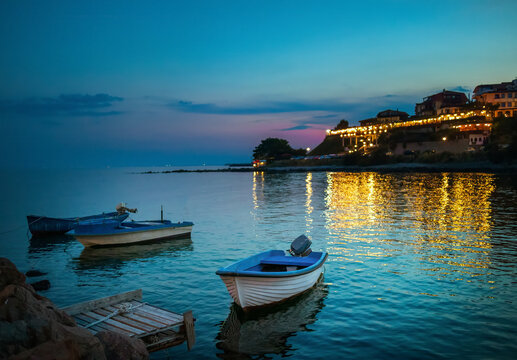 A boat parked by the shore at sunset in Nessebar, an old town on the Black Sea coast in Bulgaria.