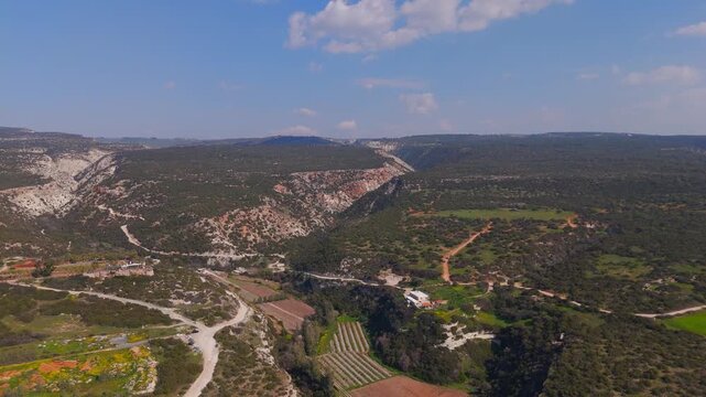 Wide Aerial View Approaching Avakas Gorge Entrance Over Rolling Hills in Paphos Cyprus