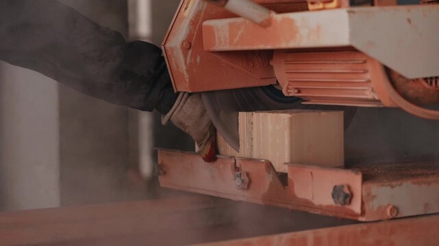 Cutting brick with stationary saw machine close up
