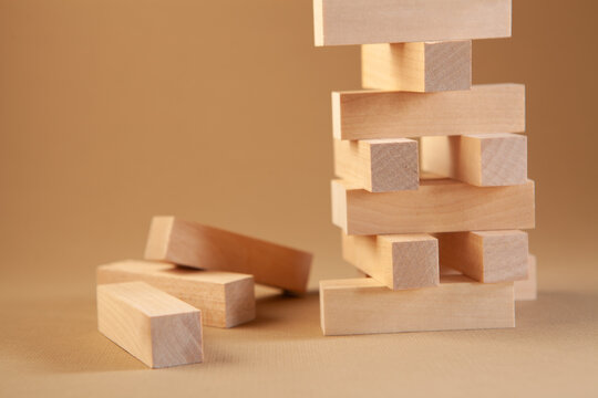 Wooden blocks tower on a brown background. Business concept, risk and strategy.