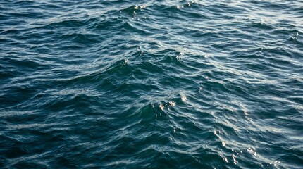 Dark, undulating ocean water reflecting a moody sky, showing depth and movement. © Omishu Makes