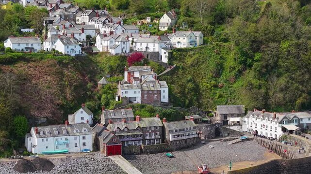 Aerial view of Clovelly Village and Harbour which is a historic 13th-century stone quay located in a privately owned, picturesque North Devon fishing village. Scenic Drone Exploration of village.