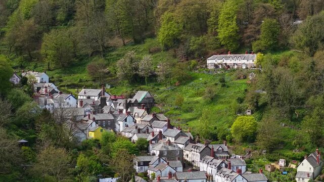 Aerial view of Clovelly Village and Harbour which is a historic 13th-century stone quay located in a privately owned, picturesque North Devon fishing village. Scenic Drone Exploration of village.