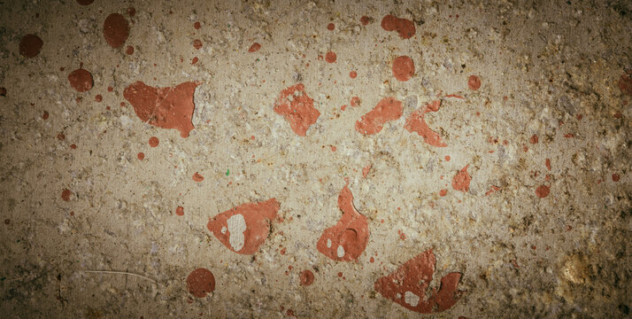 Close-up of grey concrete floor with red spots and minor imperfections. Raw, unfinished look with natural texture.