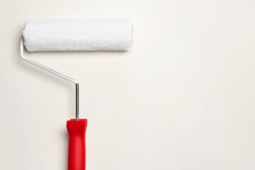 Obraz premium Roller Brush With White Cover Rests on Plain Wall With No Other Items Around in Interior Space