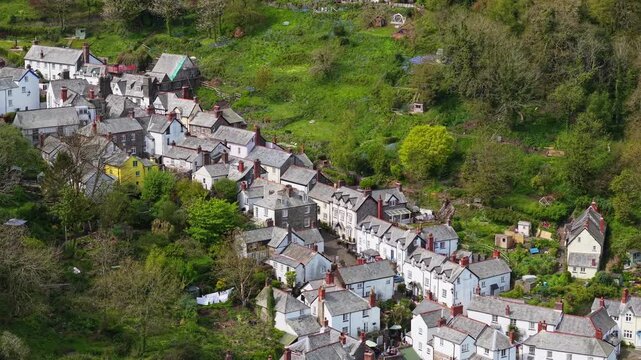 Aerial view of Clovelly Village and Harbour which is a historic 13th-century stone quay located in a privately owned, picturesque North Devon fishing village. Scenic Drone Exploration of village.
