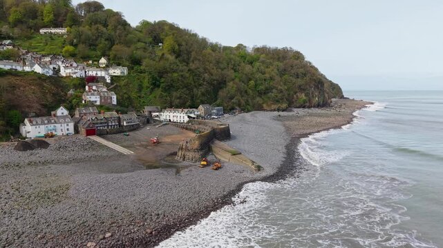 Aerial view of Clovelly Village and Harbour which is a historic 13th-century stone quay located in a privately owned, picturesque North Devon fishing village. Scenic Drone Exploration of village.