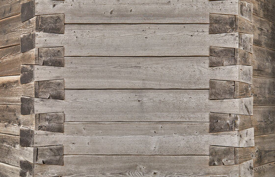 Beautiful close-up of a wooden wall with an ornate corner joint.