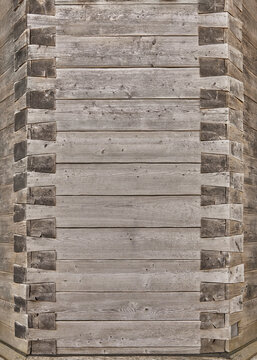 Beautiful close-up of a wooden wall with an ornate corner joint.