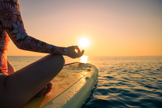 Young woman walking on sup board by the sea during summer vacation