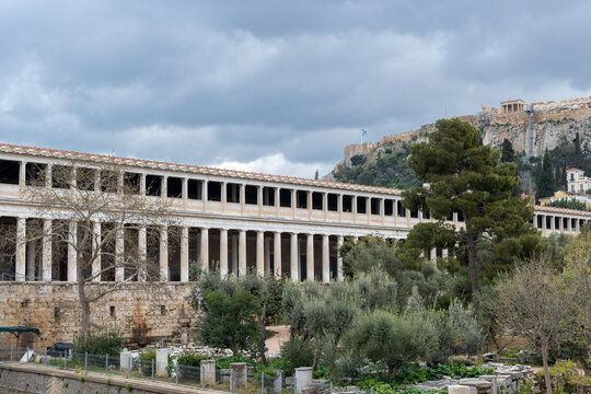 Photo of the Stoa of Attalos , the Museum of the Ancient Agora at Athens-Greece. Sky with clouds at the background, the Acropolis behind the building.