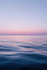 Obraz premium Vertical calm water surface: serene ocean reflection at dawn