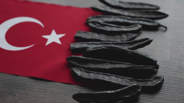 Close-up of carob pods on Turkish flag 